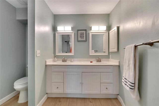 bathroom with vanity, wood-type flooring, and toilet