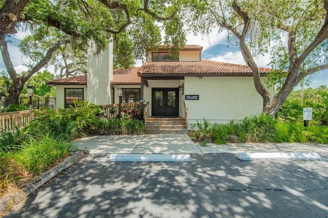 mediterranean / spanish house featuring french doors