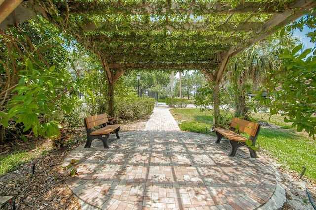 view of property's community with a pergola and a patio