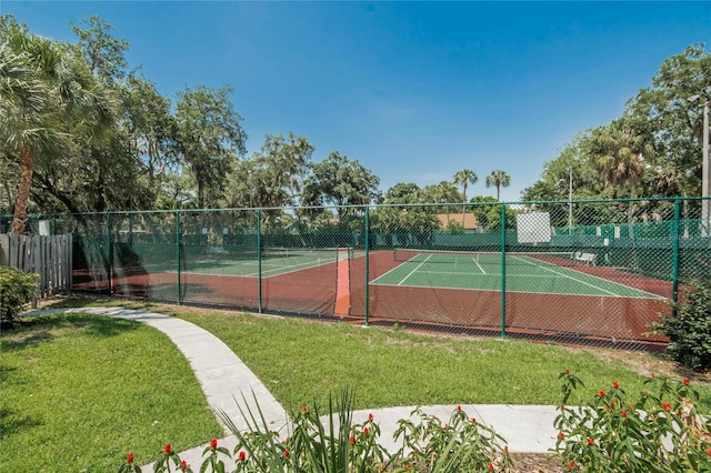 view of sport court with a yard