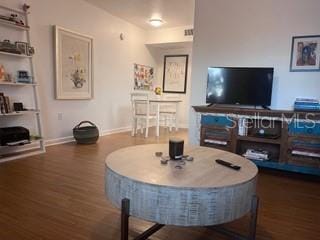 living room with dark wood-type flooring