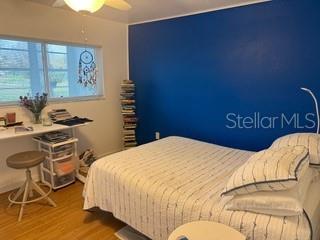 bedroom with hardwood / wood-style flooring and ceiling fan