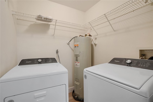 washroom featuring electric water heater and washer and dryer