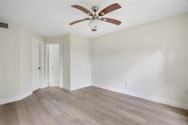 empty room with ceiling fan and light hardwood / wood-style flooring