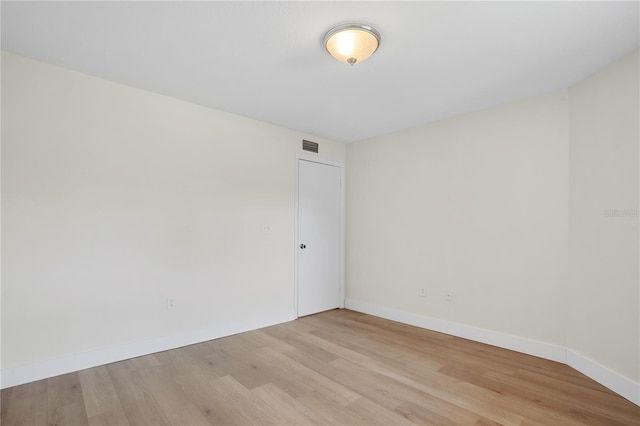 spare room with light wood-type flooring