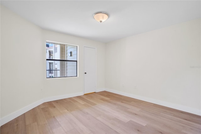 spare room with light hardwood / wood-style flooring