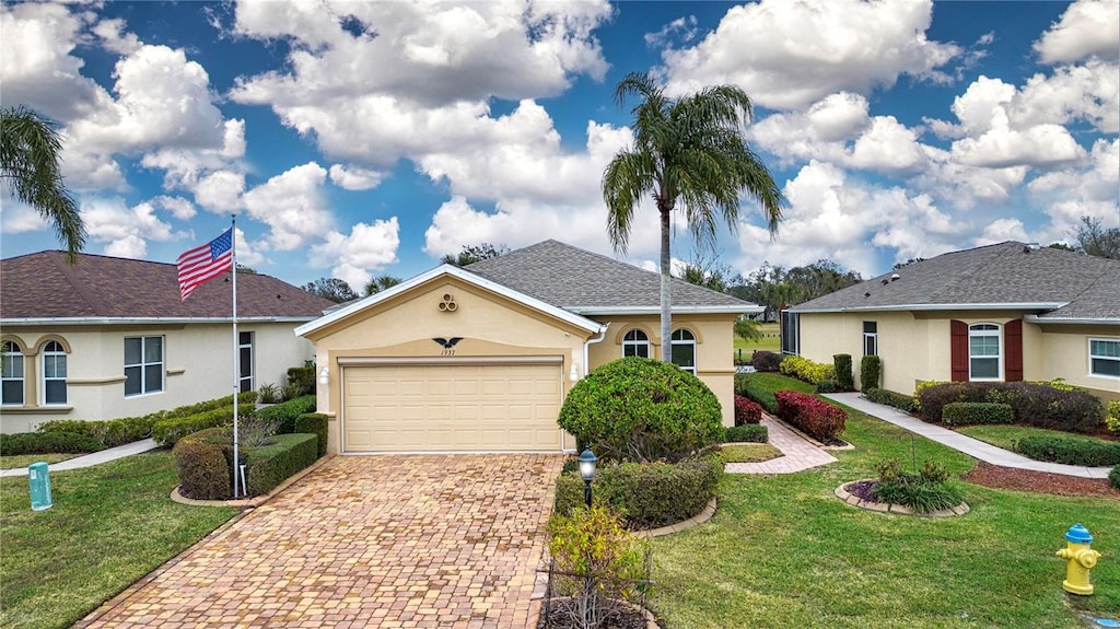 ranch-style home featuring a garage and a front yard