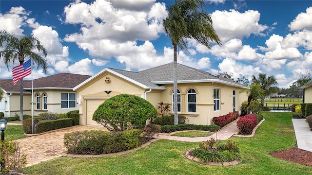 ranch-style house with a garage and a front yard