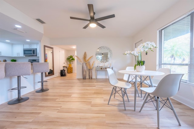 dining area featuring ceiling fan, a healthy amount of sunlight, and light hardwood / wood-style flooring