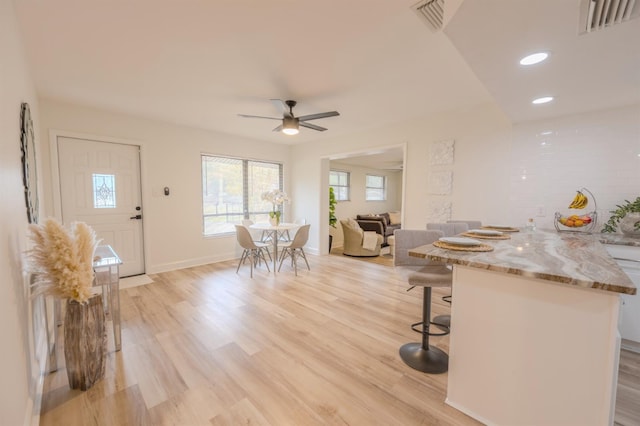 unfurnished dining area with light hardwood / wood-style floors and ceiling fan