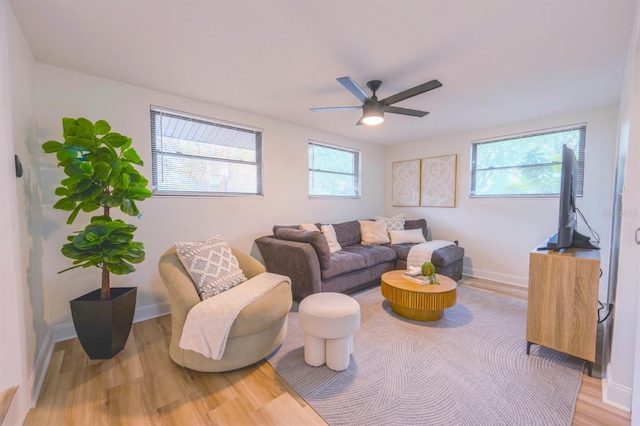 living room with a healthy amount of sunlight, hardwood / wood-style flooring, and ceiling fan