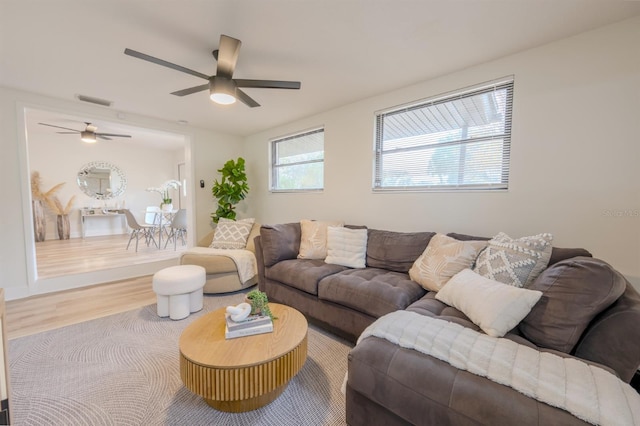 living room with hardwood / wood-style flooring and ceiling fan