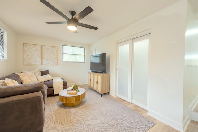 living room with ceiling fan and light hardwood / wood-style floors