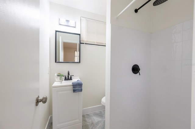 bathroom with sink, toilet, and a tile shower