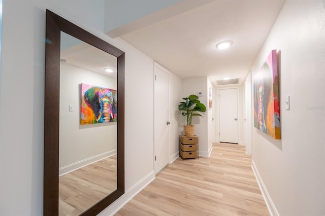 corridor with light wood-type flooring