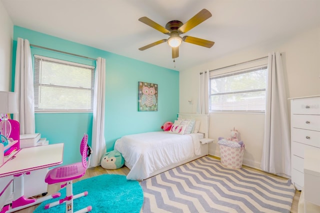 bedroom with light wood-type flooring and ceiling fan