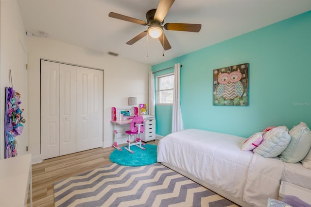 bedroom featuring a closet, ceiling fan, and light wood-type flooring