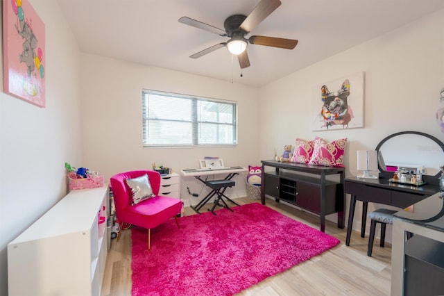 playroom with light hardwood / wood-style flooring and ceiling fan