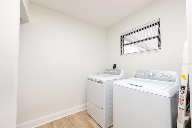 laundry room featuring light hardwood / wood-style floors and separate washer and dryer