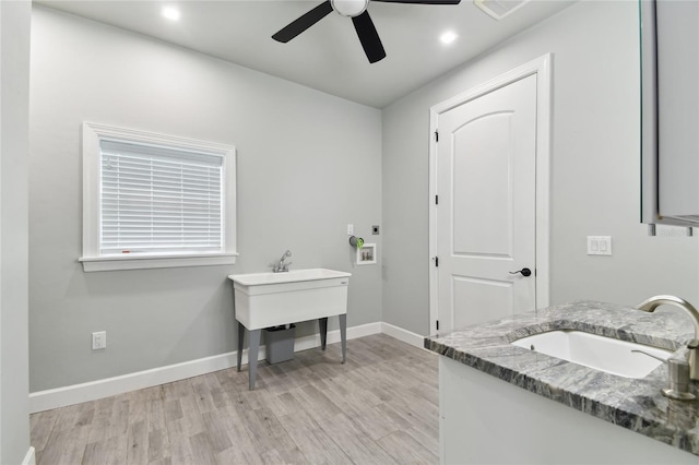 bathroom with wood-type flooring, ceiling fan, and vanity