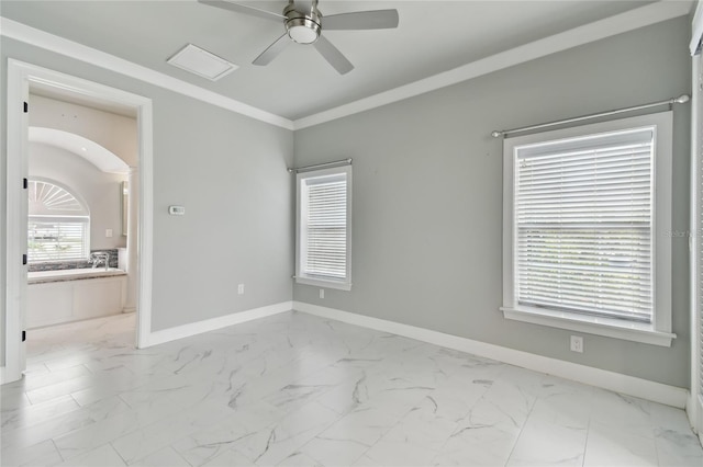 unfurnished room featuring ceiling fan and crown molding