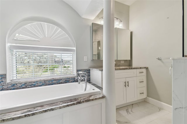 bathroom featuring vanity, plenty of natural light, and a bathing tub