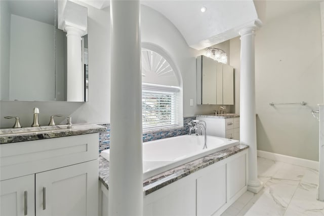 bathroom with lofted ceiling, vanity, and ornate columns