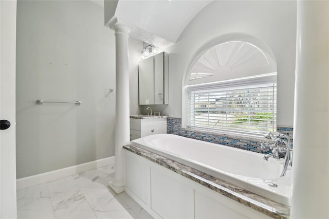 bathroom with a tub, vaulted ceiling, and vanity