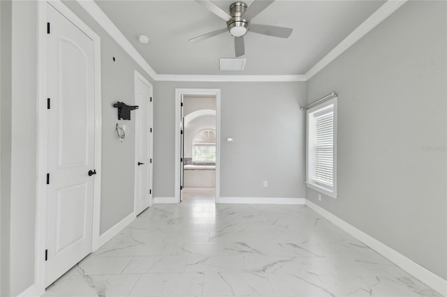 empty room featuring crown molding and ceiling fan