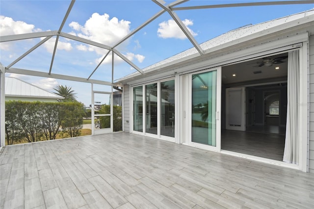 unfurnished sunroom with vaulted ceiling and ceiling fan