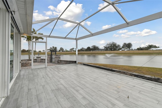 exterior space featuring glass enclosure and a water view