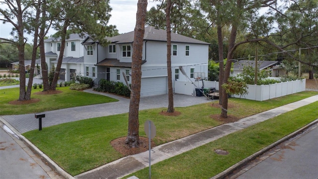 view of front of house featuring a garage and a front yard