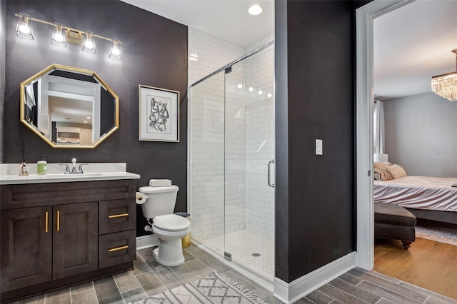 bathroom featuring toilet, vanity, and walk in shower