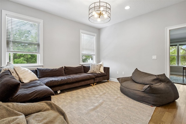 living room with a notable chandelier and light wood-type flooring