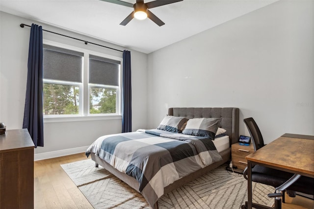 bedroom with ceiling fan and light hardwood / wood-style floors