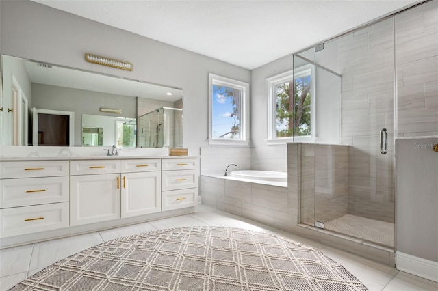 bathroom with shower with separate bathtub and vanity