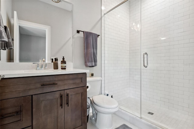 bathroom with vanity, toilet, and a shower with shower door