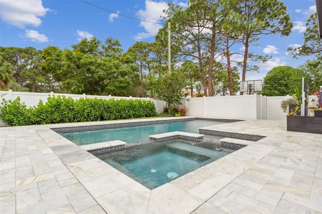 view of swimming pool featuring a patio area and an in ground hot tub