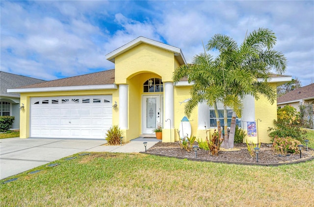 view of front of home featuring a garage and a front yard