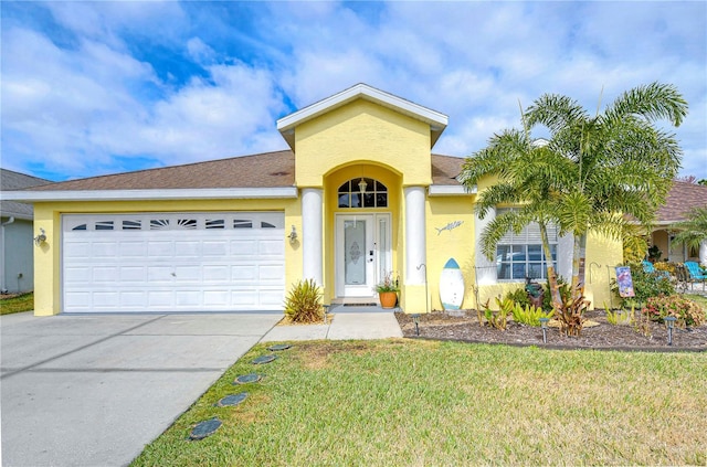 view of front of property with a garage and a front lawn