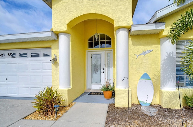 view of exterior entry with a garage