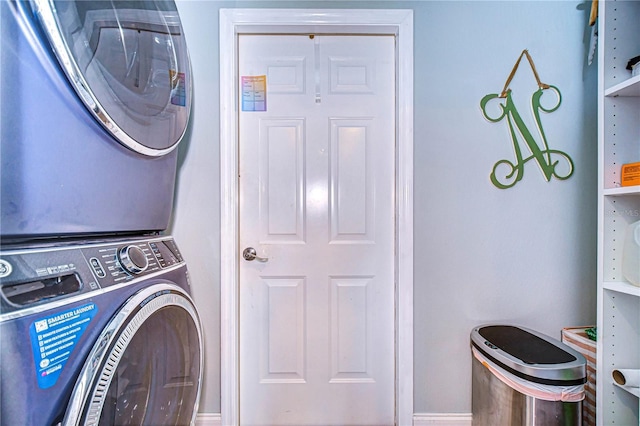 laundry room with stacked washing maching and dryer