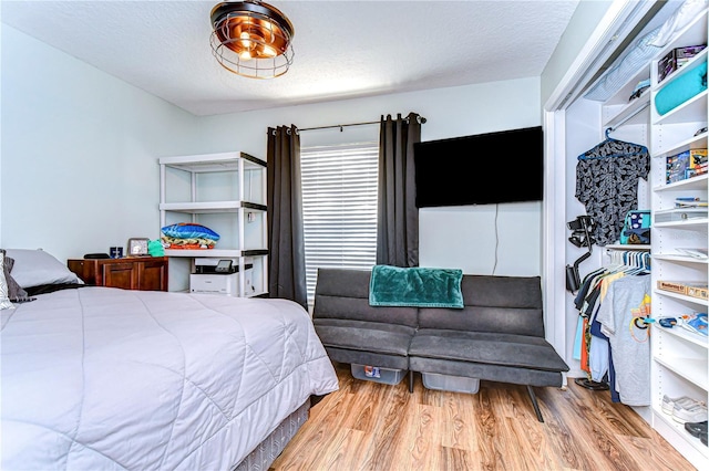 bedroom featuring hardwood / wood-style floors and a textured ceiling