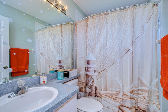 bathroom with vanity, curtained shower, and toilet