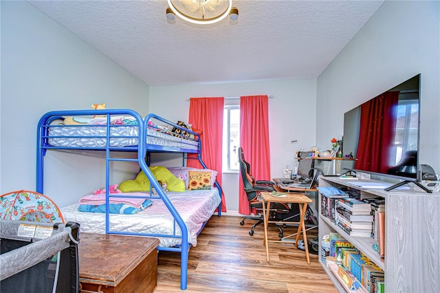 bedroom featuring hardwood / wood-style flooring and a textured ceiling