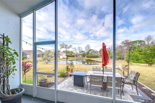 sunroom / solarium with a wealth of natural light and a water view