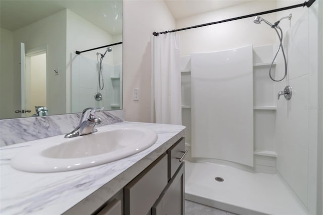 bathroom featuring vanity and curtained shower