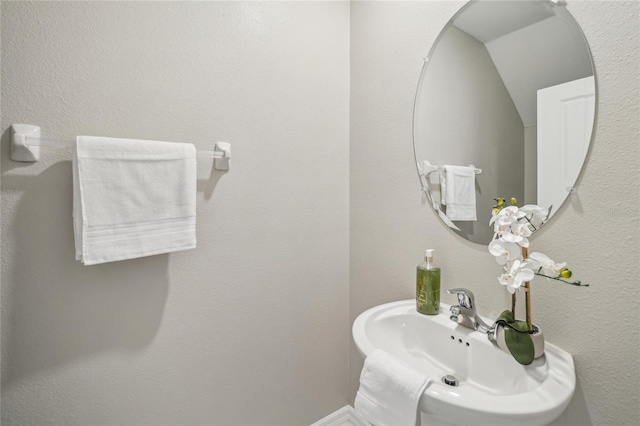 bathroom featuring sink and vaulted ceiling