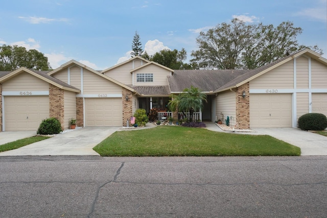 view of front of home with a garage and a front lawn