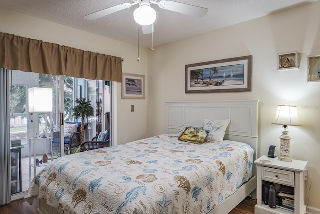 bedroom featuring a textured ceiling, dark hardwood / wood-style floors, and ceiling fan